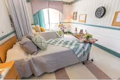 Cozy patient bedroom with bed, window, and wall decorations.