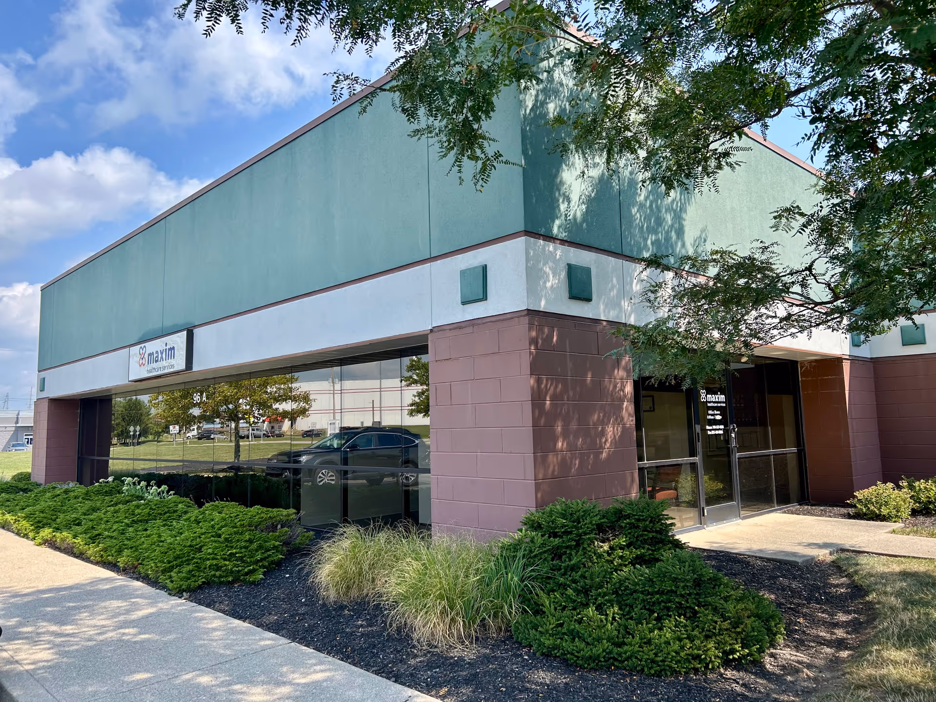 Exterior view of Maxim Healthcare Newark regional office with landscaping