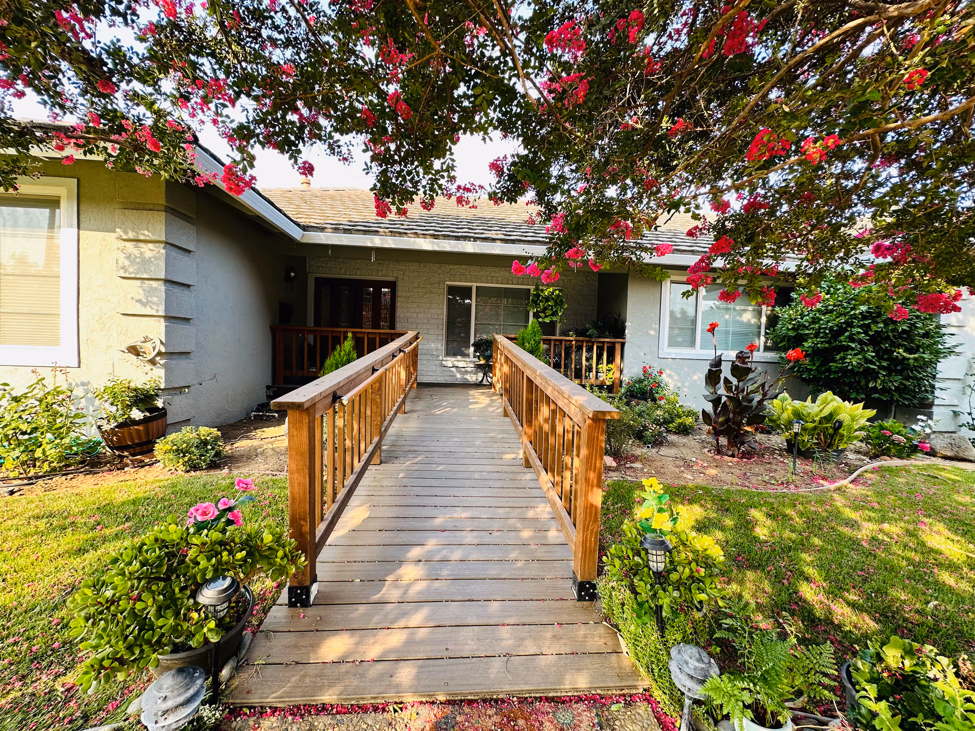 Front exterior view of Wimbledon Walnut Creek Care Home with wooden ramp and garden