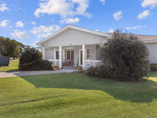 Front exterior of a single-story Good Samaritan Society facility with a porch and green lawn