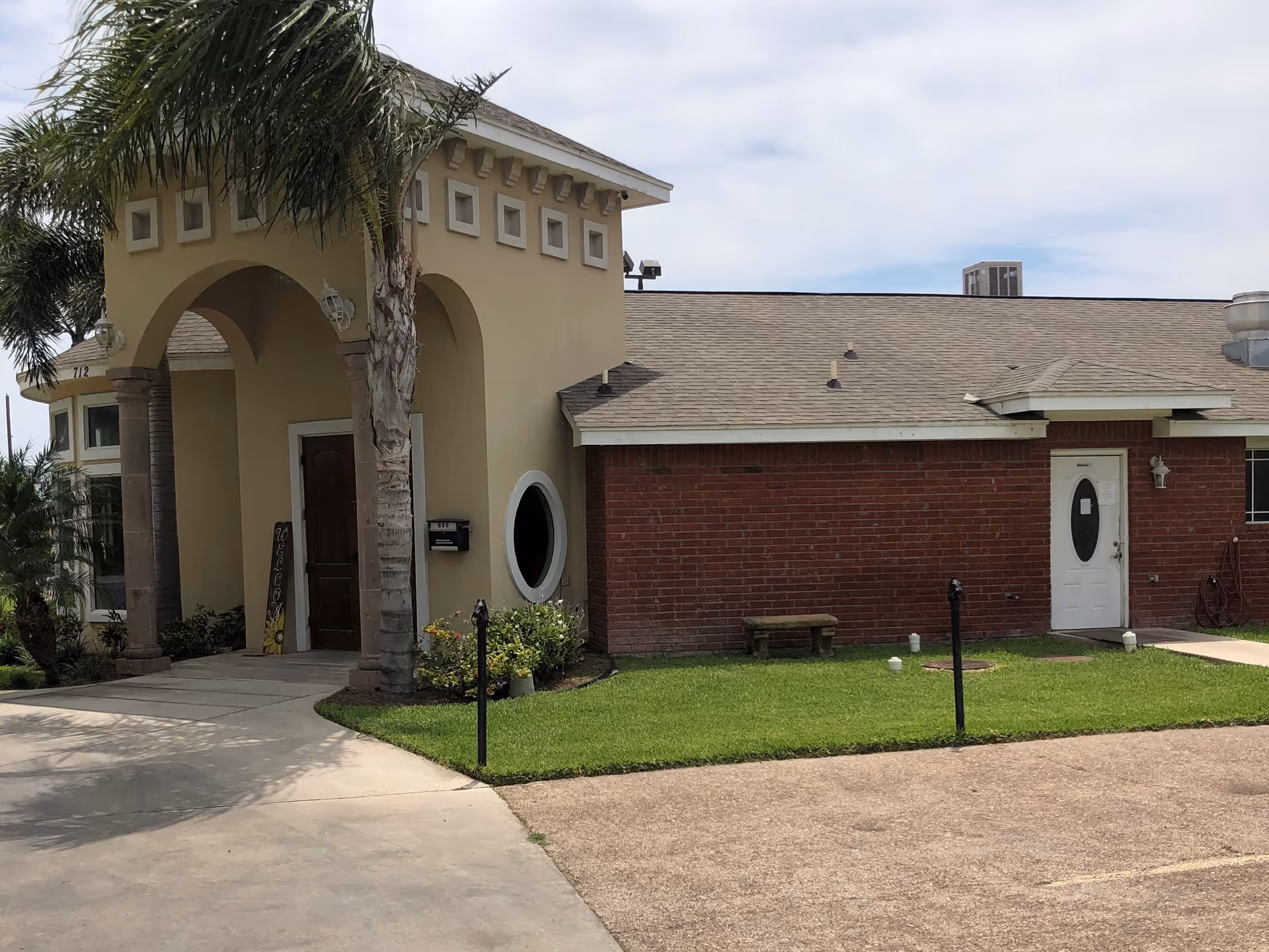 Exterior view of Barcelona Assisted Living entrance with arches.