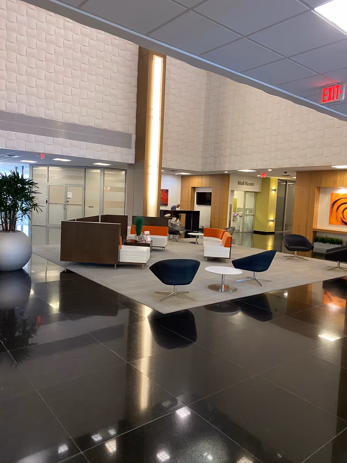 Interior lobby of a senior care facility featuring modern seating, a plant, and glossy floors.