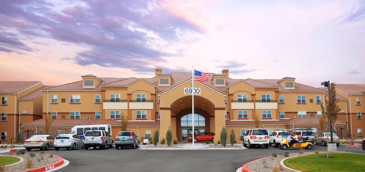 Exterior view of Coronado Villa Retirement Resort front entrance with parked cars.