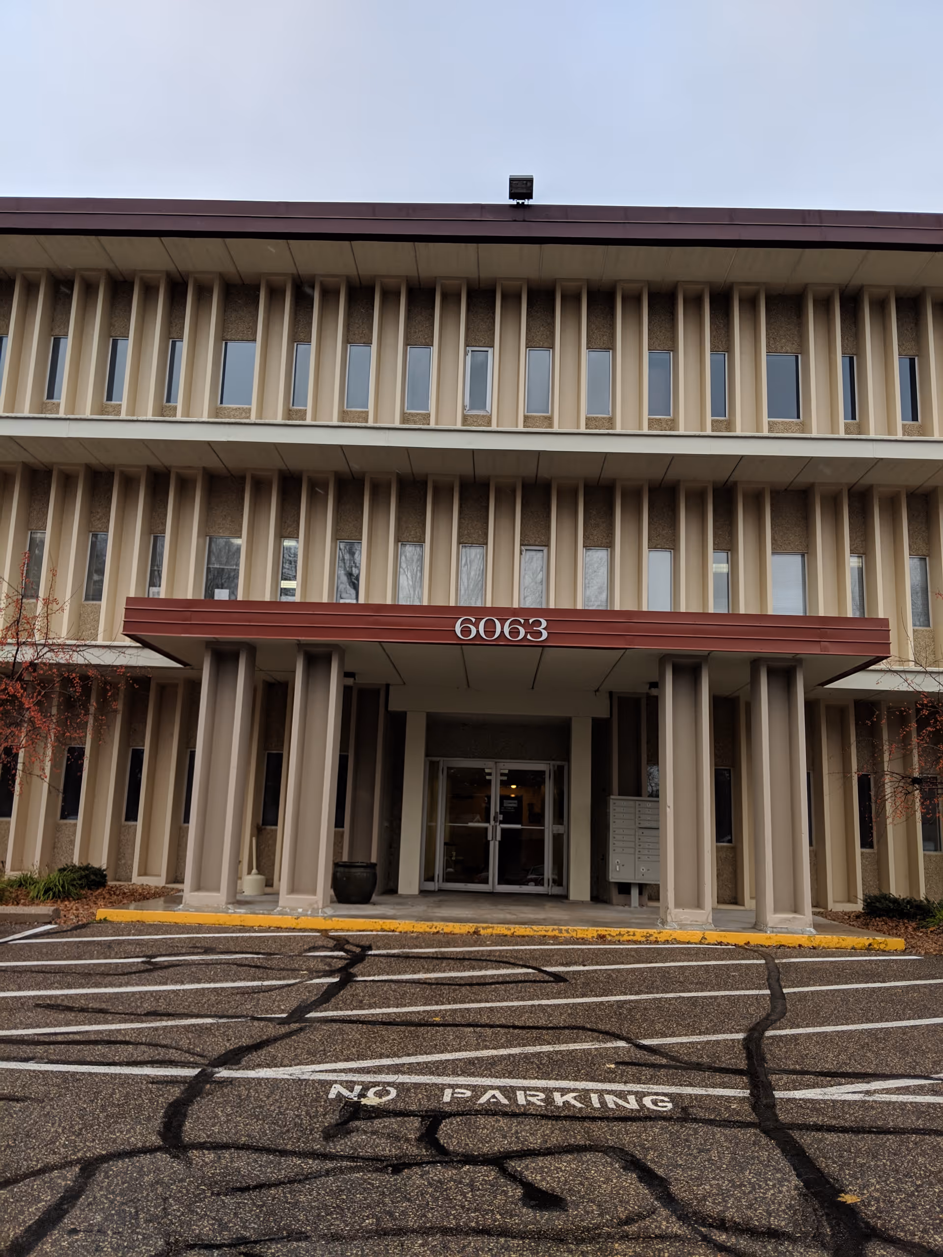 Exterior view of a senior care facility front entrance with the address 6063.