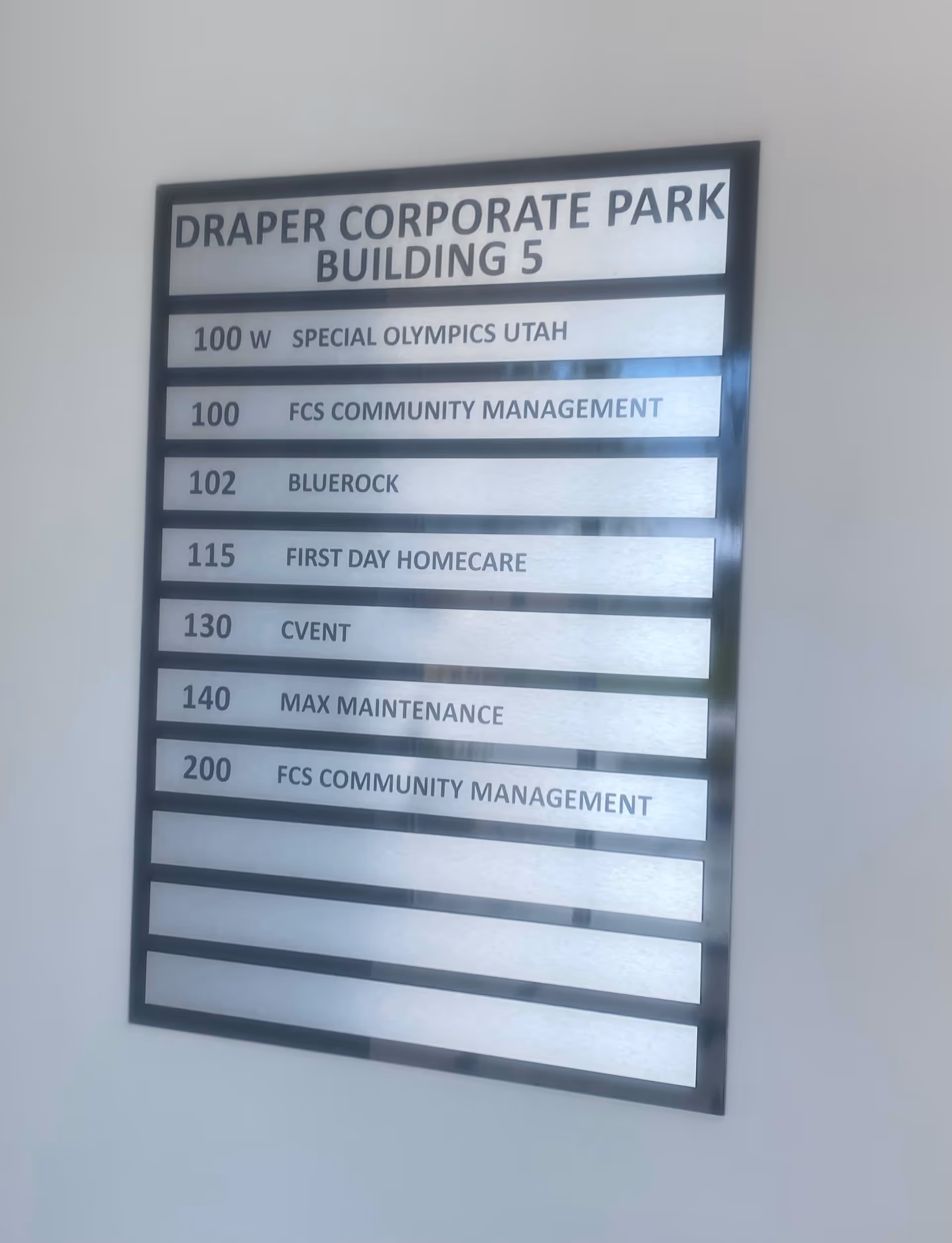 Wall-mounted directory sign listing Draper Corporate Park Building 5 and tenants.