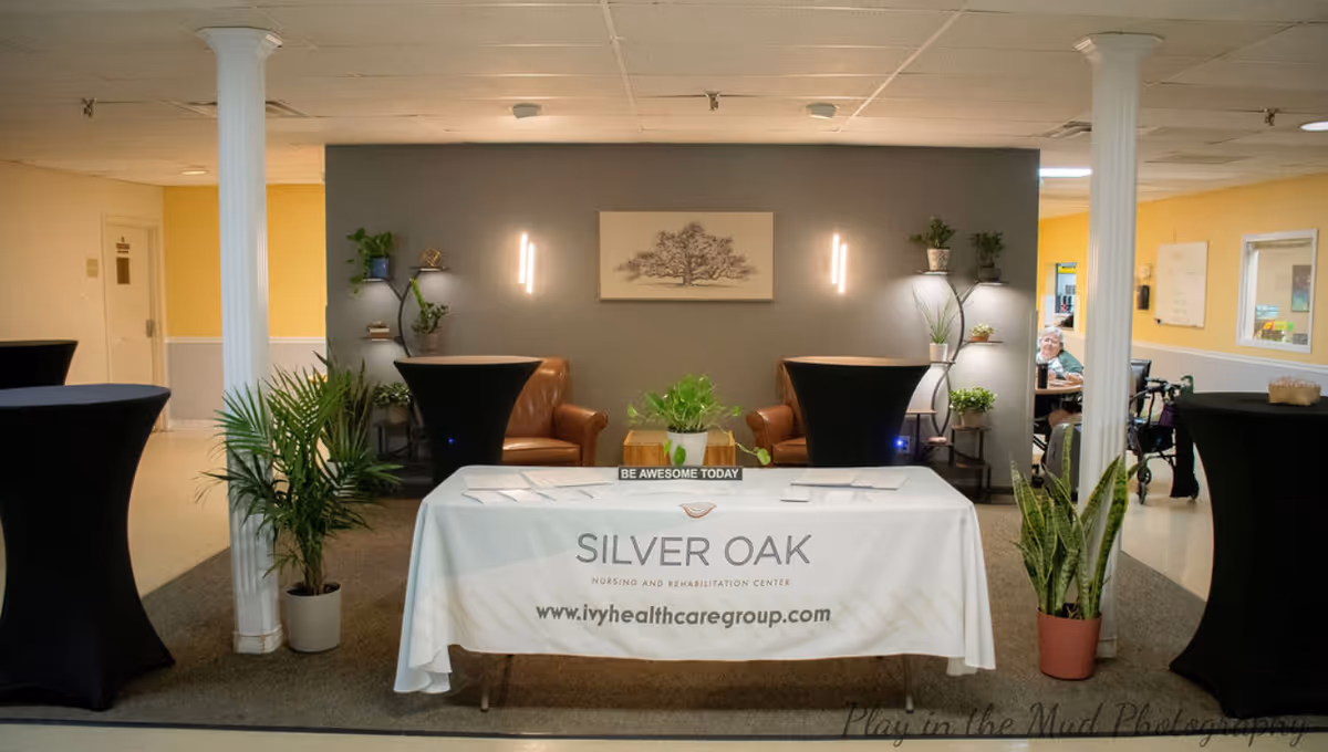 Interior lobby of Willow Gardens Care Center with reception table and seating.