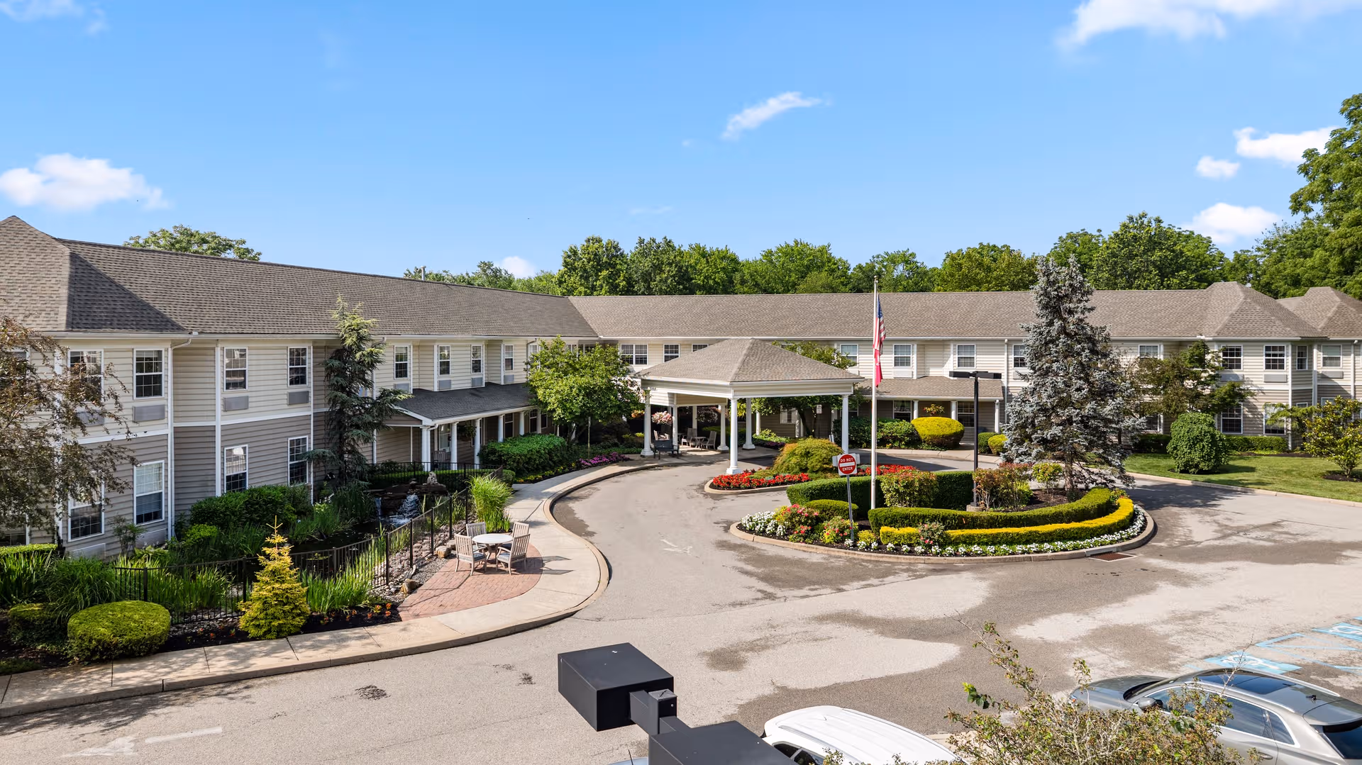 Exterior view of Dresher Estates by Priority Life Care with circular drive and landscaped entrance.