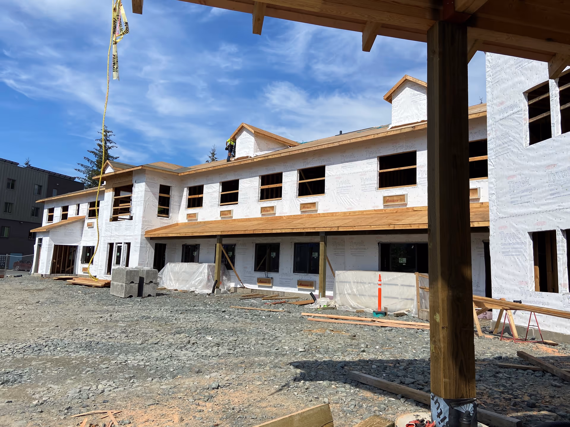 Under-construction Riverview Senior Living building exterior with workers and construction materials.