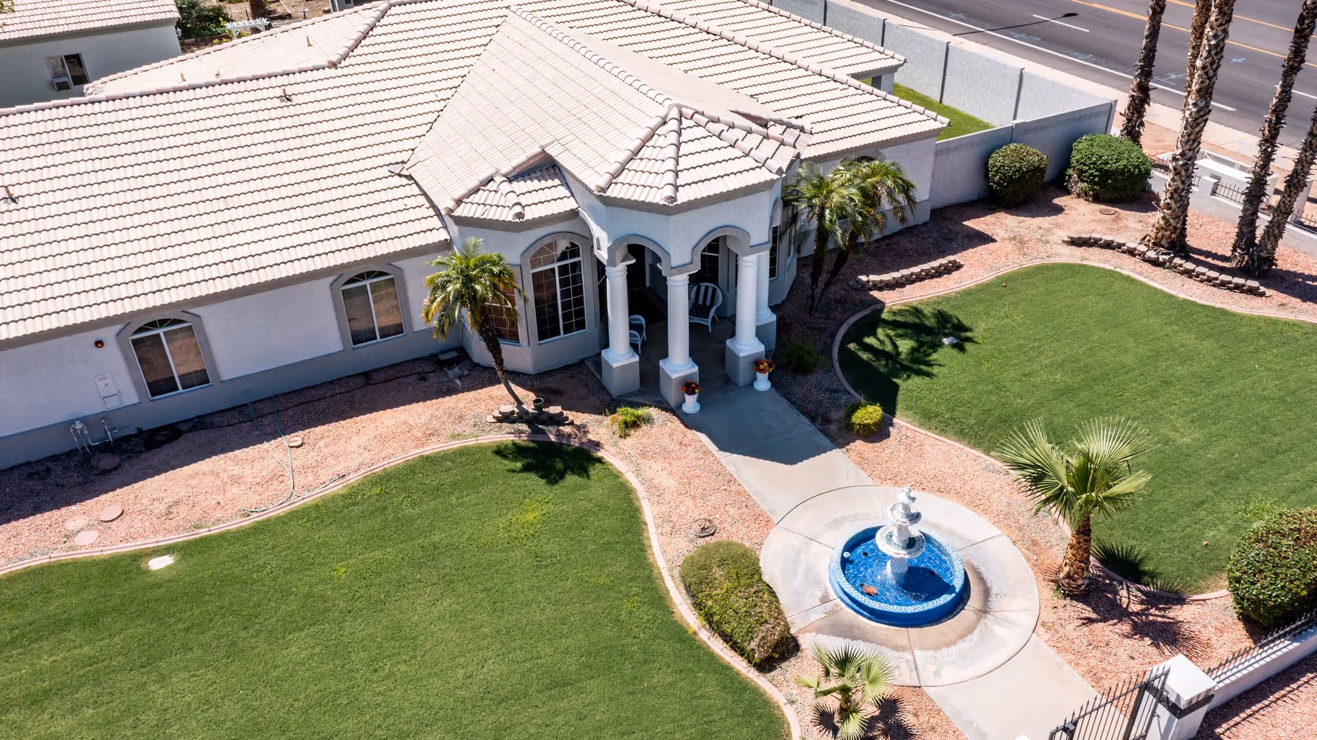 Front entrance of Jones Family Care Home, a single-story senior living facility with palm trees.