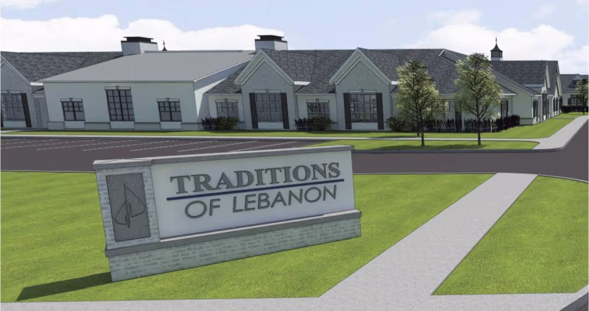 Exterior rendering of Traditions of Lebanon senior living with sign and landscaping.