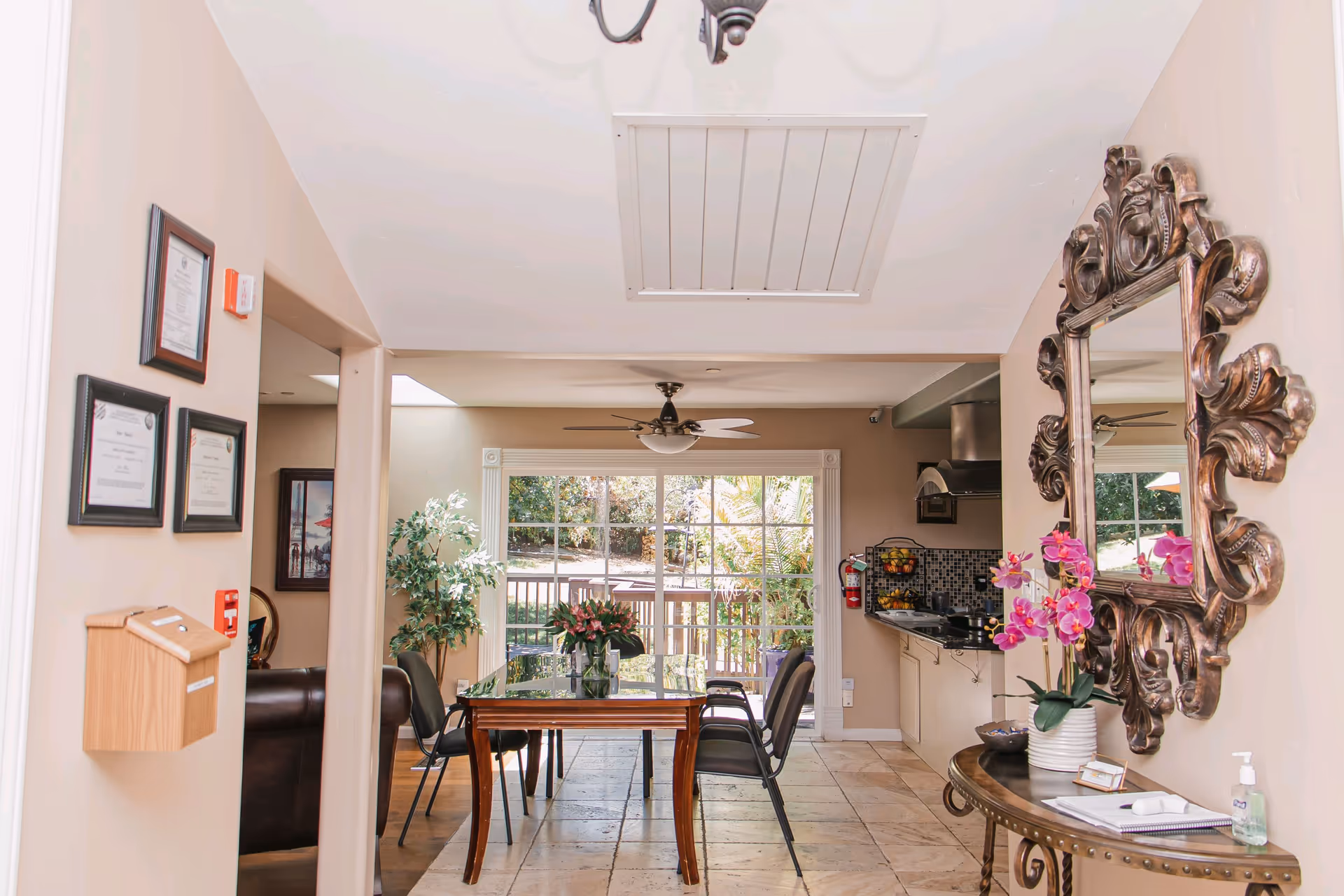 Interior dining area with a wood table, chairs, and an ornate mirror.