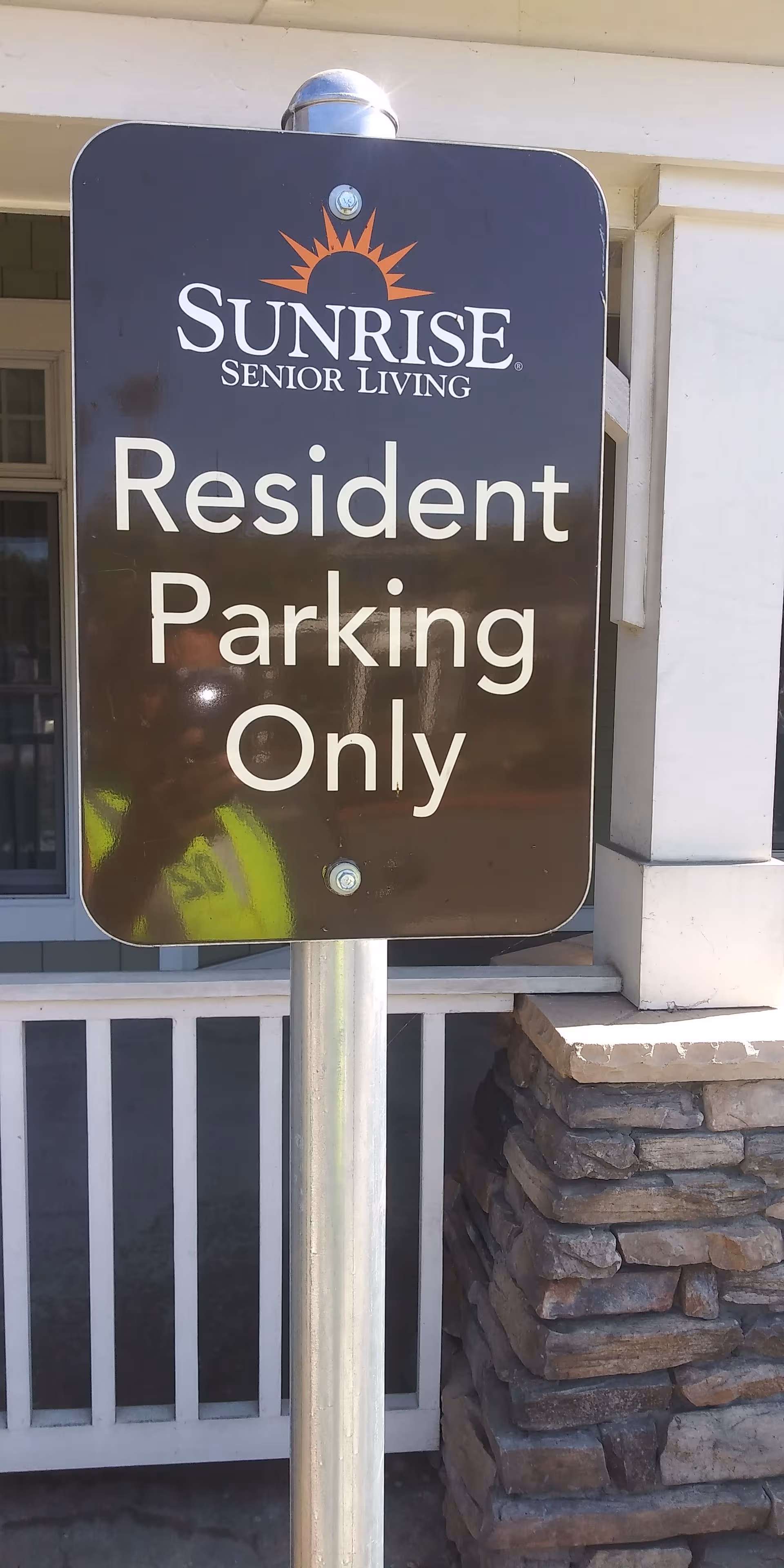 Sunrise Senior Living sign reading Resident Parking Only at a building entrance