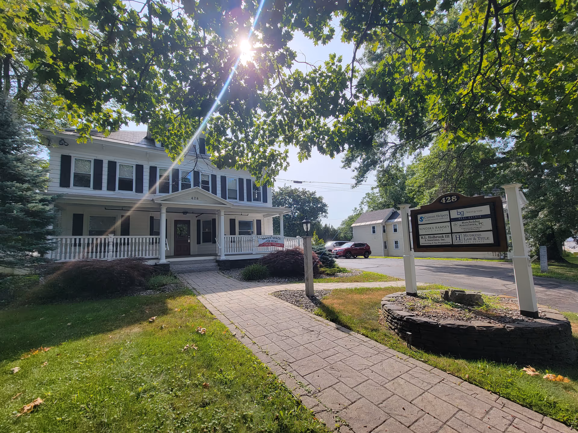 Two-story building with front porch and outdoor sign for Custom Helpers Home Health Care.