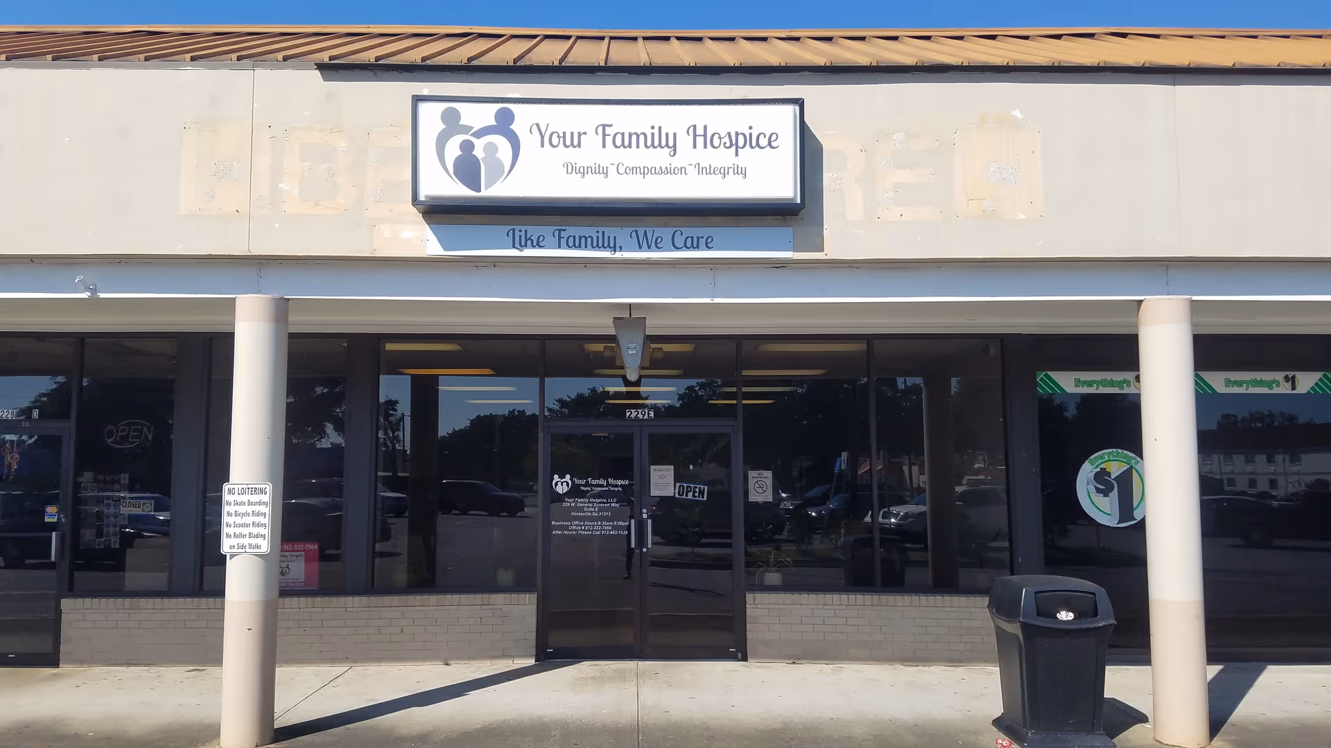 Exterior view of Your Family Hospice storefront with glass entry doors.