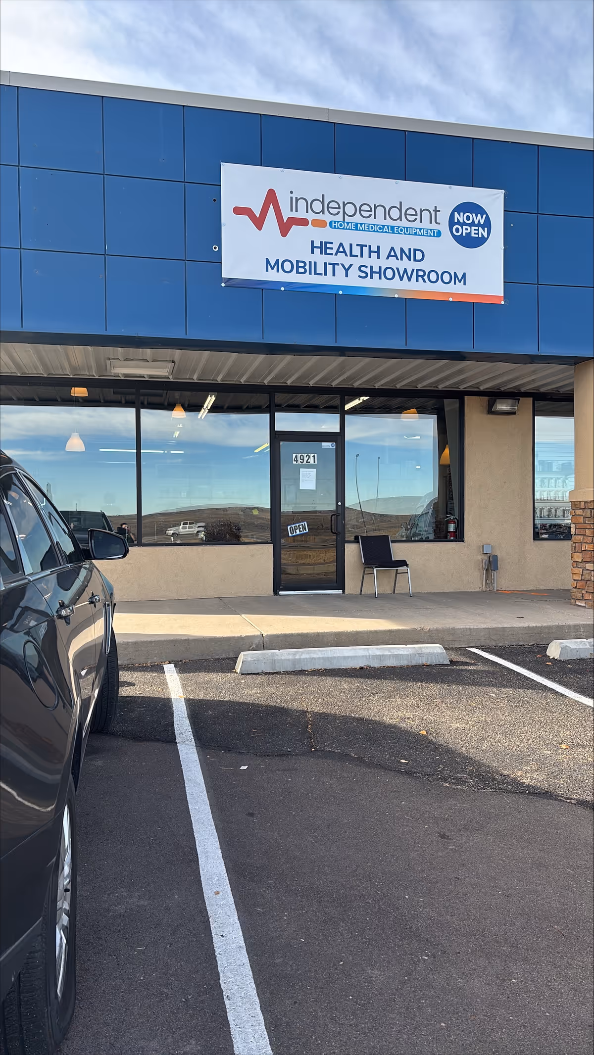 Exterior view of a blue building with Independent Home Medical Equipment showroom sign.