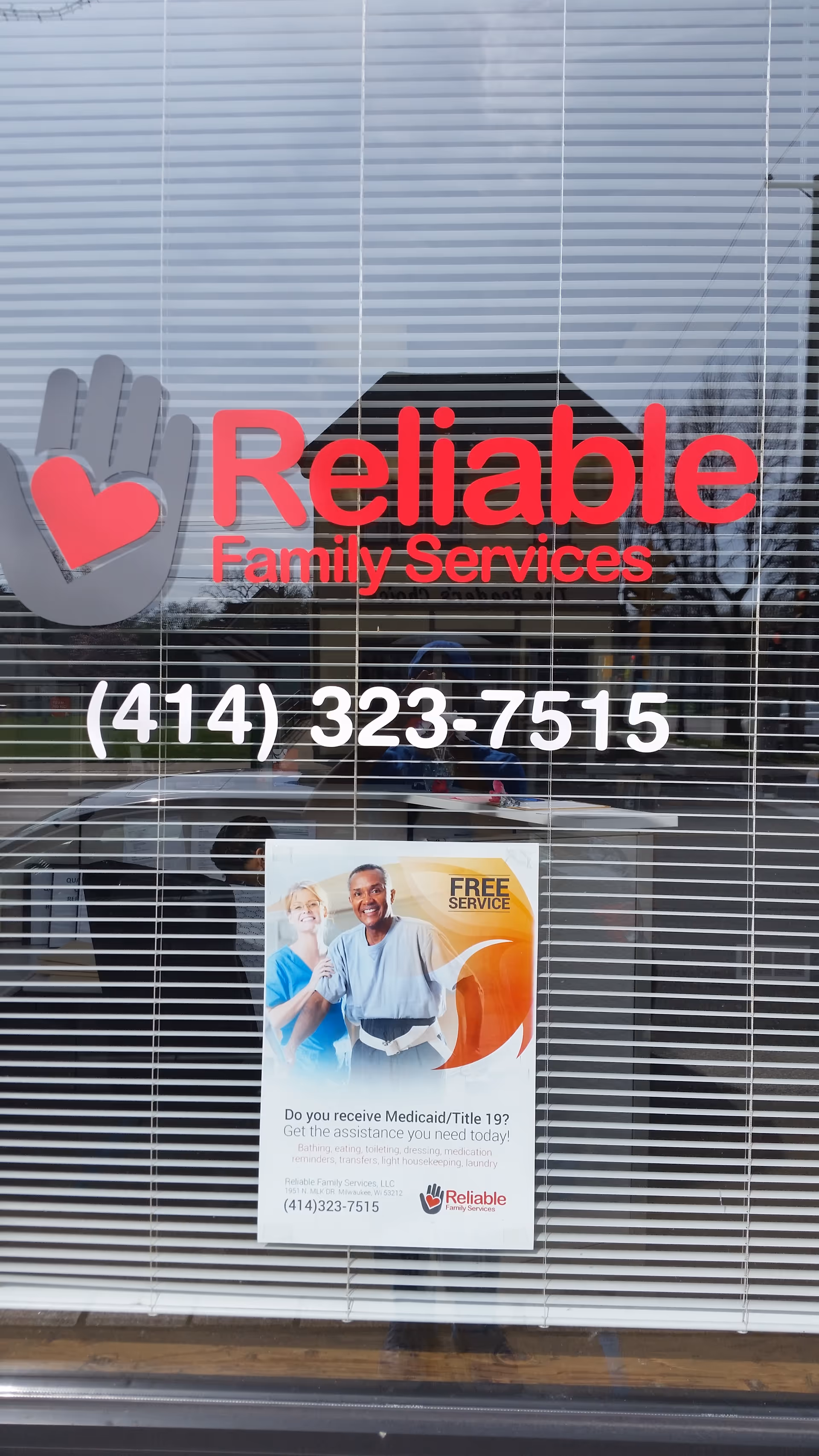 Glass storefront with Reliable Family Services logo, phone number, and a posted flyer.