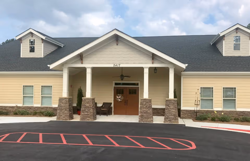 Exterior view of Marquis Mill Park entrance with pillars and double doors.