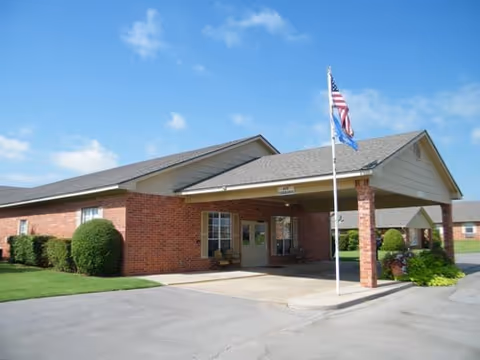 Brick Deer View Manor senior living facility with a covered entrance and flagpole.