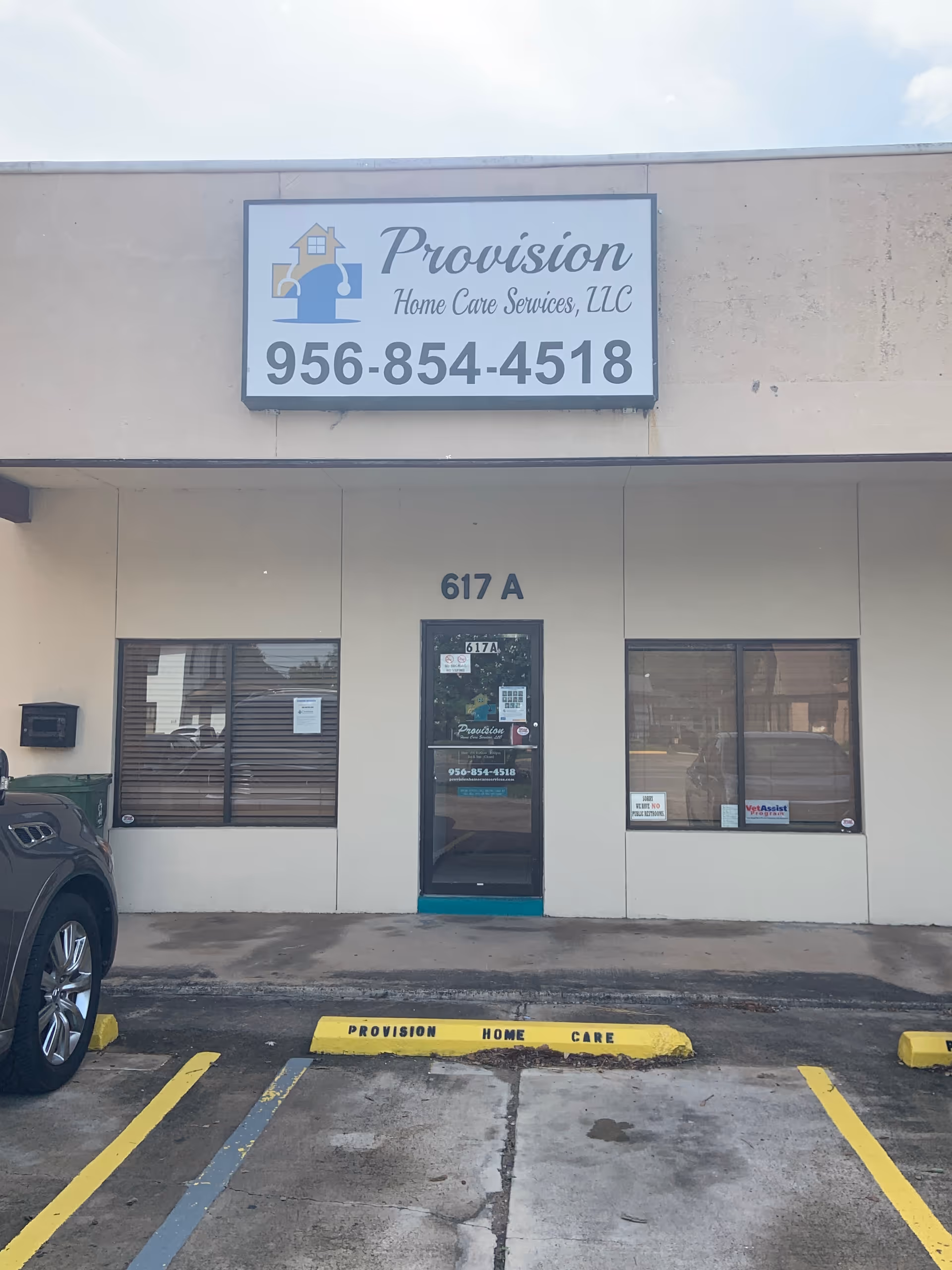 Front view of Provision Home Care Services storefront with entrance and parking.