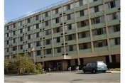 Exterior view of Osage Nursing Home building with entrance and parked cars.