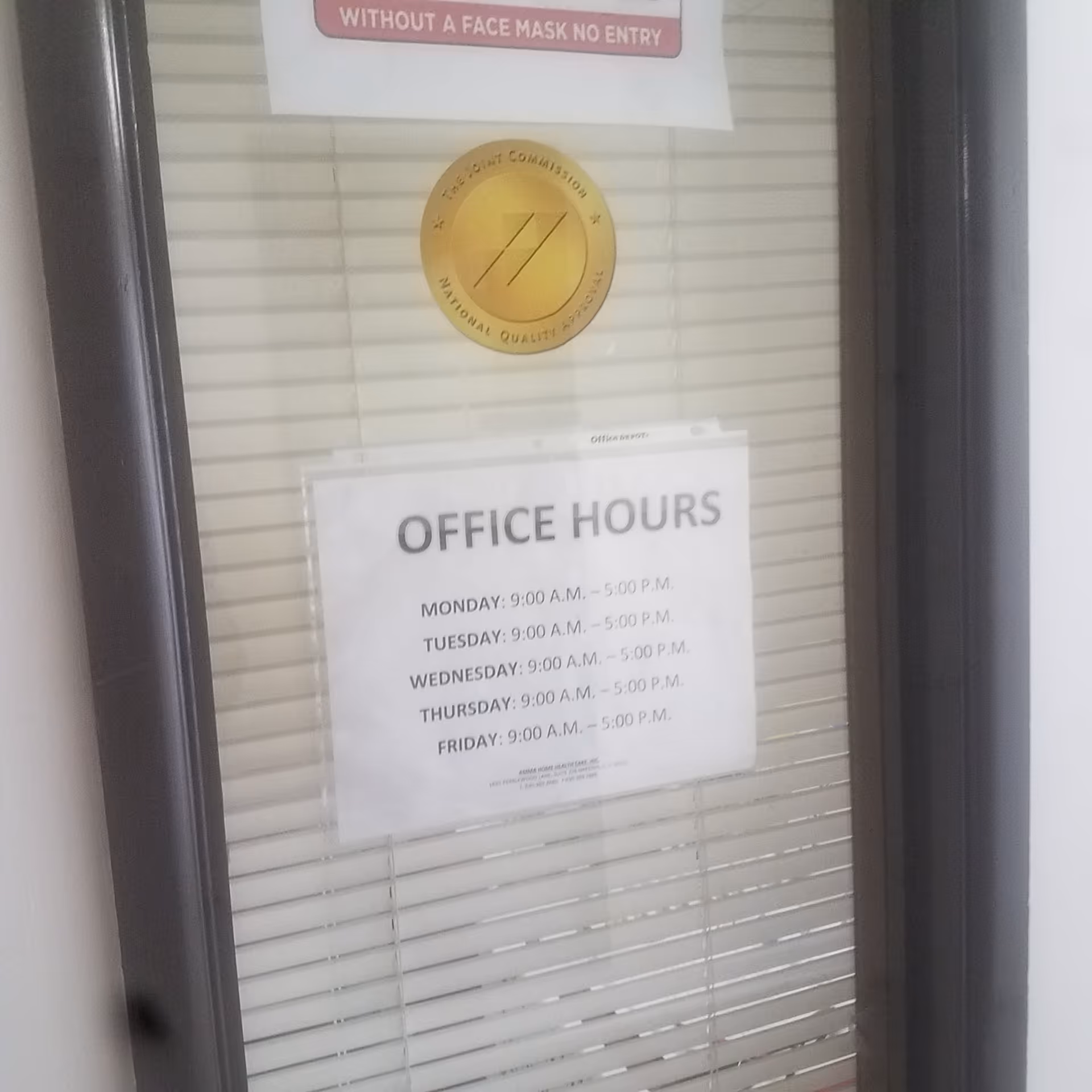 Interior door with blinds and posted office hours sign and gold seal.