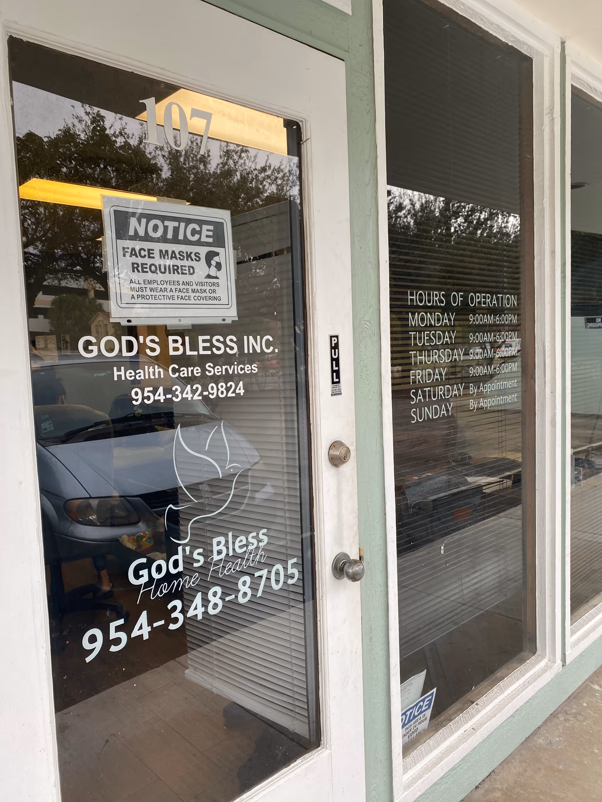 Glass storefront with God's Bless Inc. signage and operating hours.