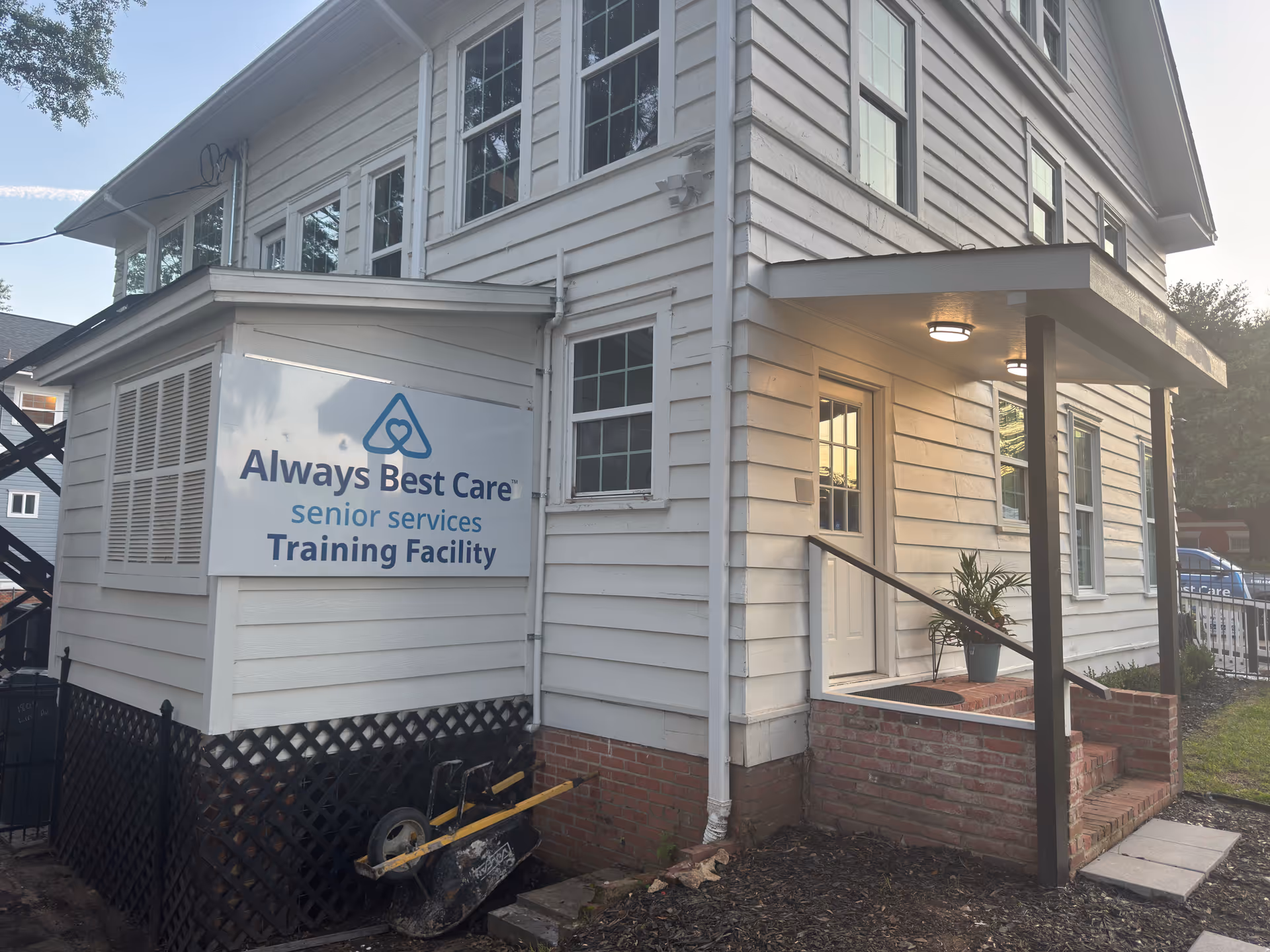 White two-story building with a sign reading Always Best Care Training Facility.