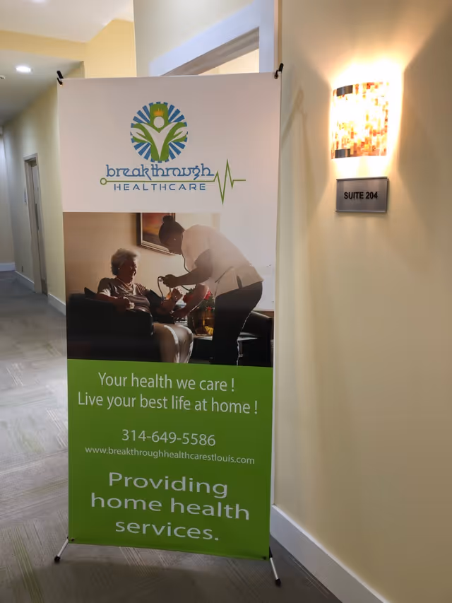 Indoor hallway featuring a Breakthrough Healthcare banner and a Suite 204 wall plaque.