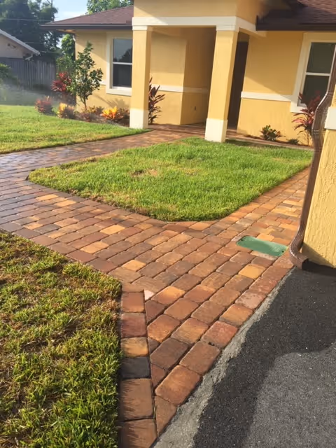 Exterior view of Path of Life building with brick walkway and well-kept lawn.