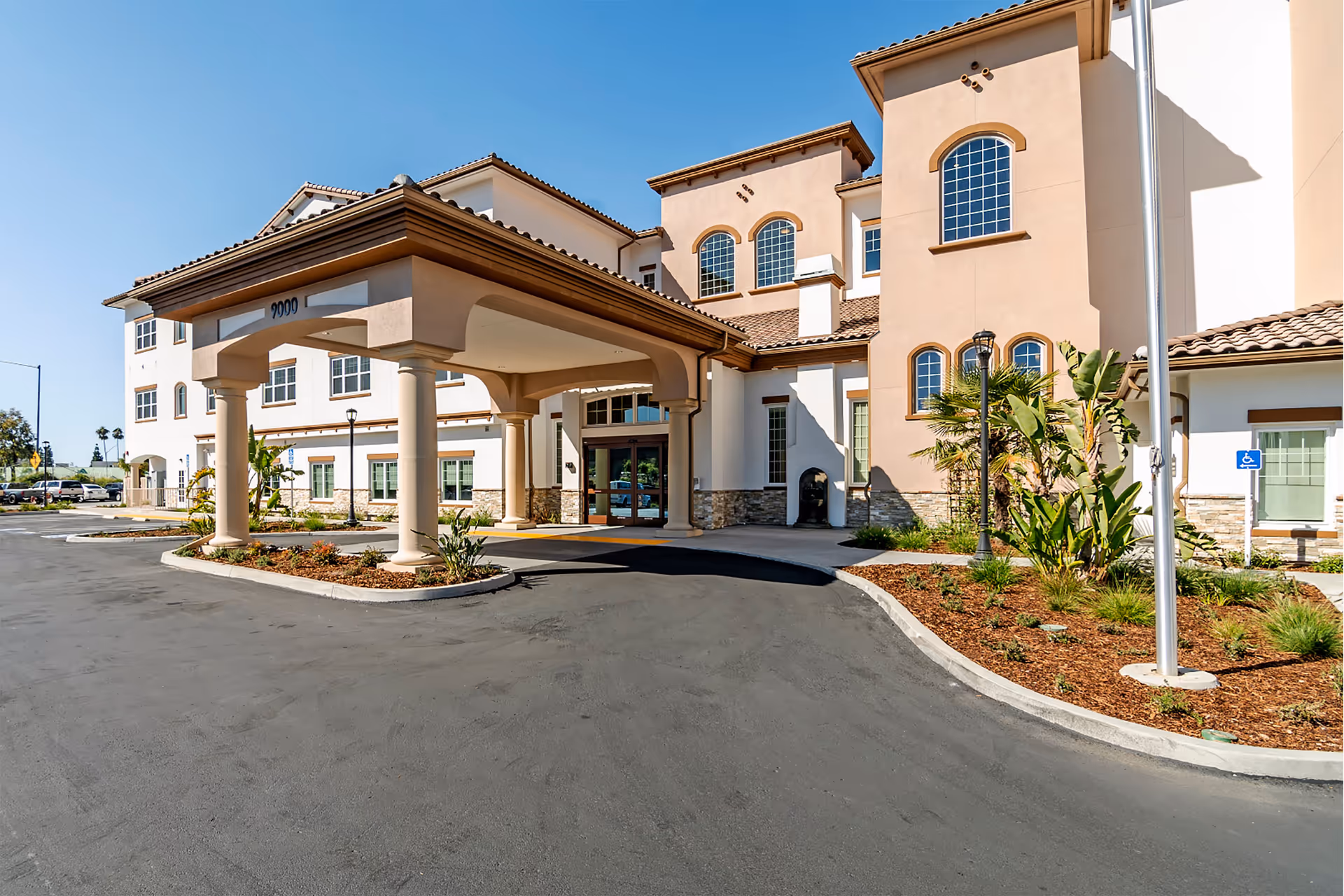 Front exterior view of Westmont of La Mesa senior living facility with covered entrance.