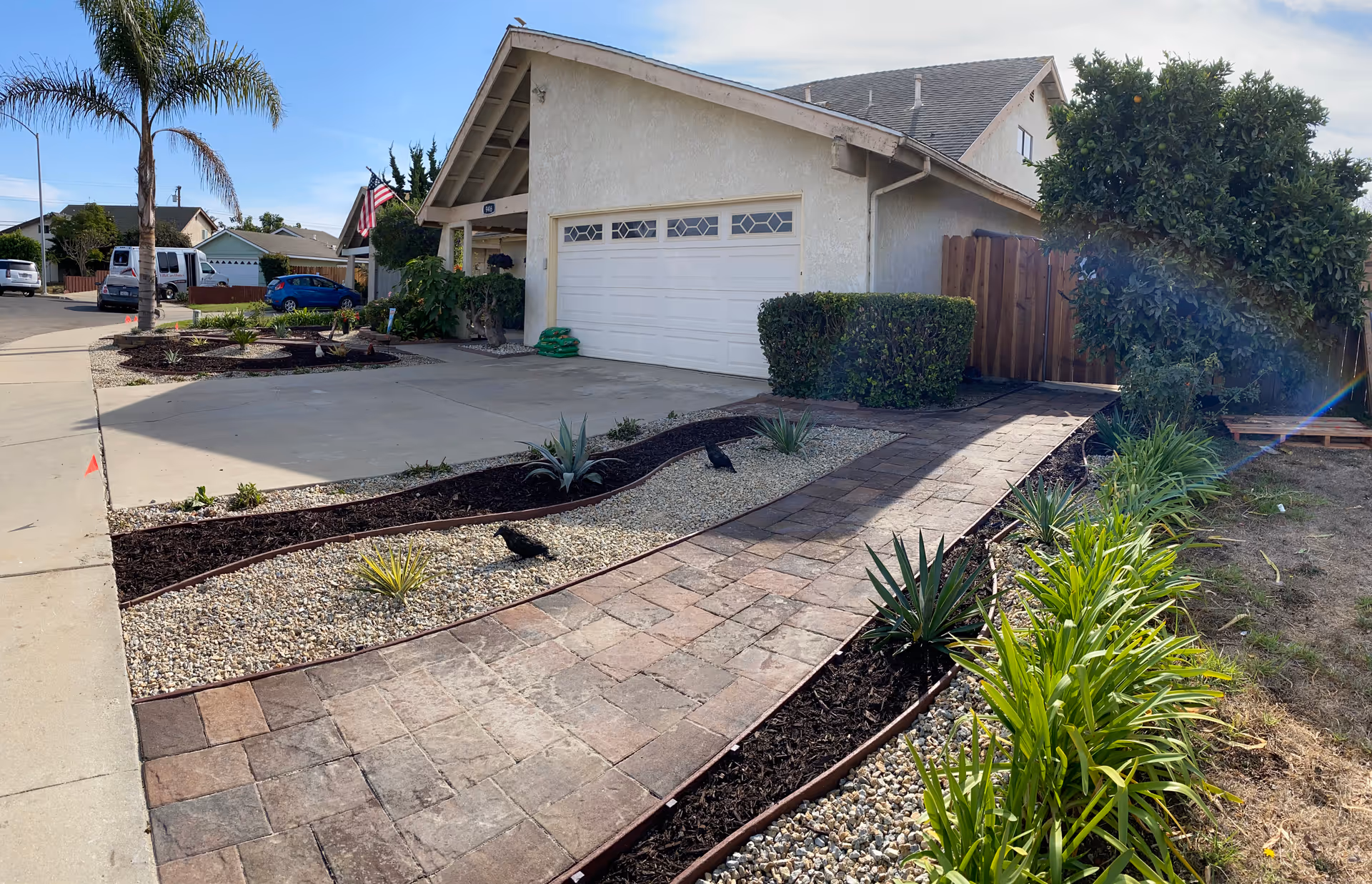 Front exterior of a single-story home with a garage and landscaped yard.