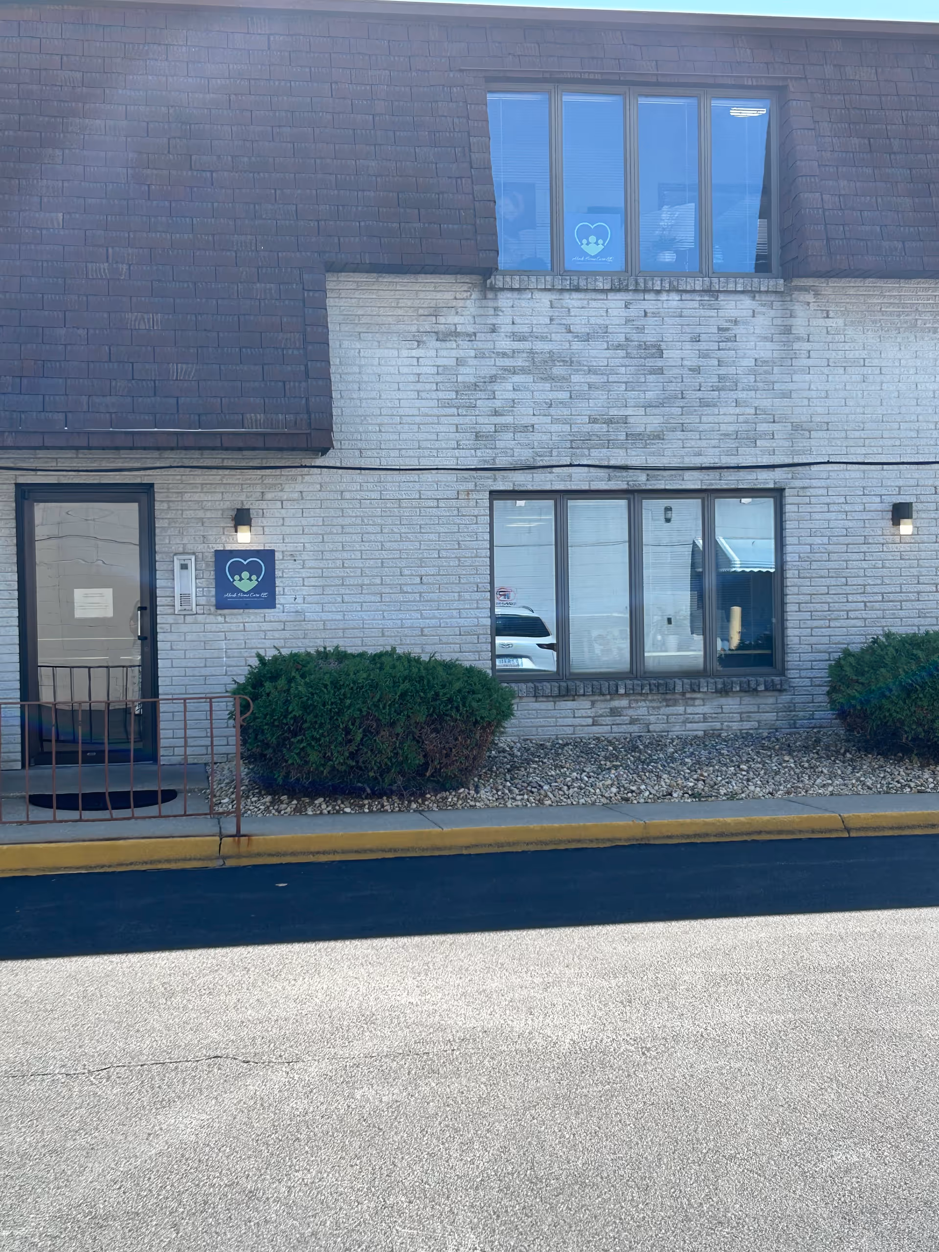 Exterior view of Abode Home Care, LLC building front with sign and windows