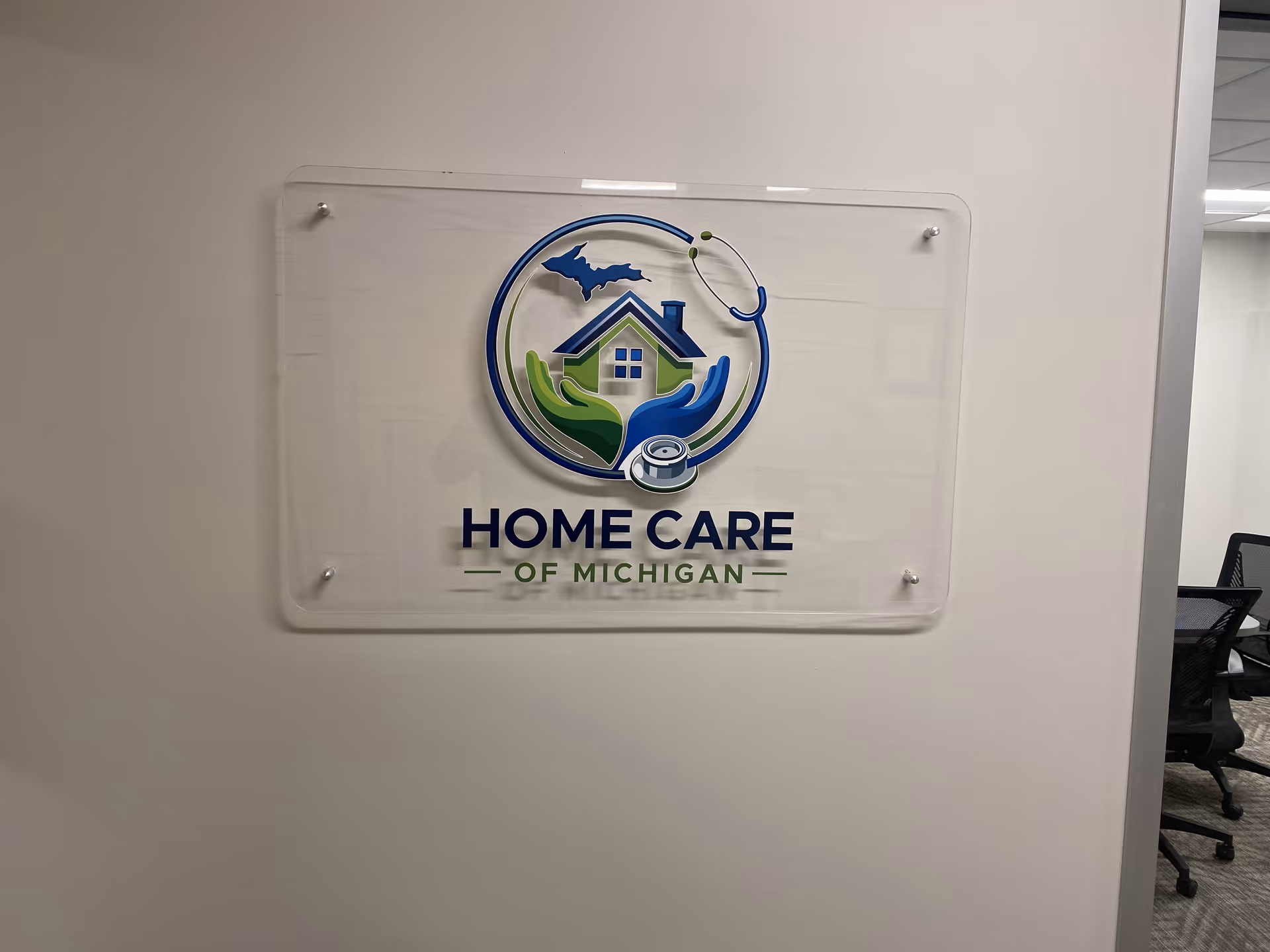 Interior wall plaque displaying Home Care of Michigan logo and branding