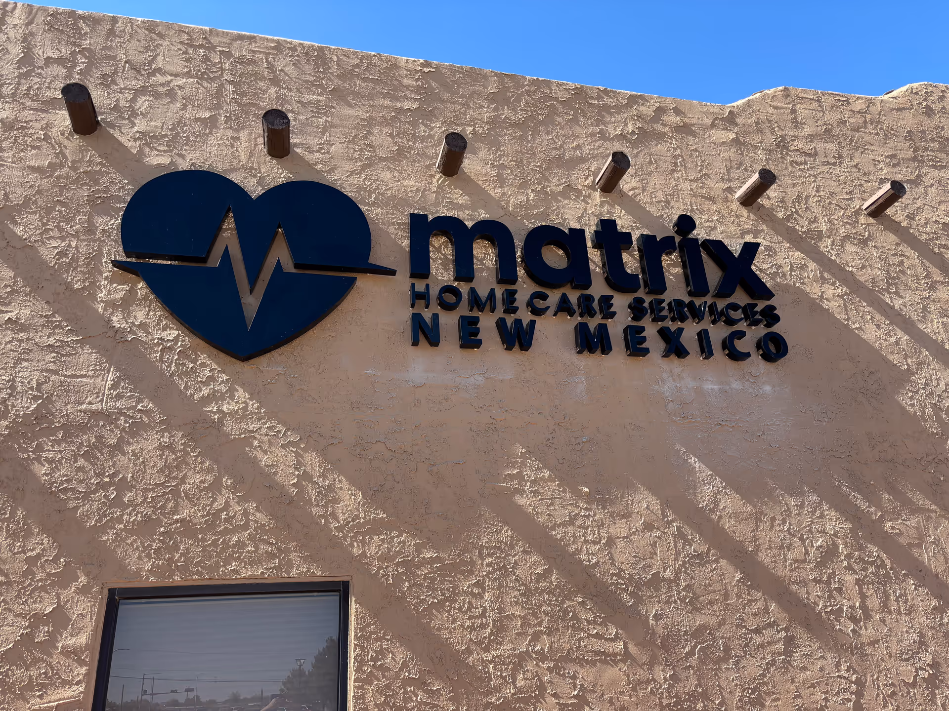 Exterior wall of Matrix Home Care Services New Mexico with blue heart logo.