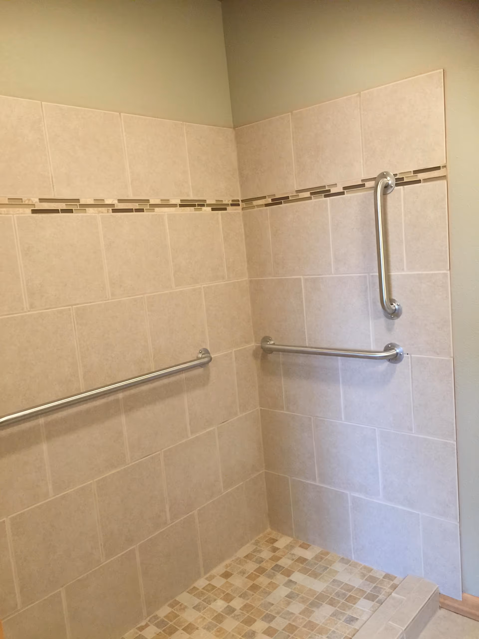 Accessible bathroom in Mountlake Terrace AFH with grab bars and tiled walls.