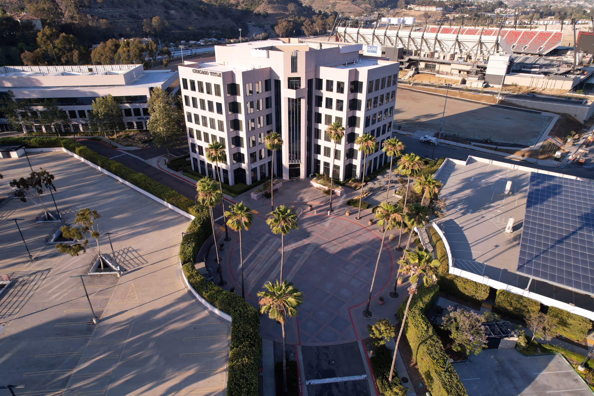 Aerial view of a modern Mission Healthcare building surrounded by palm trees and parking.