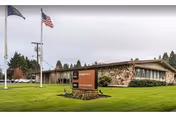 Marquis Springfield senior living building with flagpoles and manicured lawn.