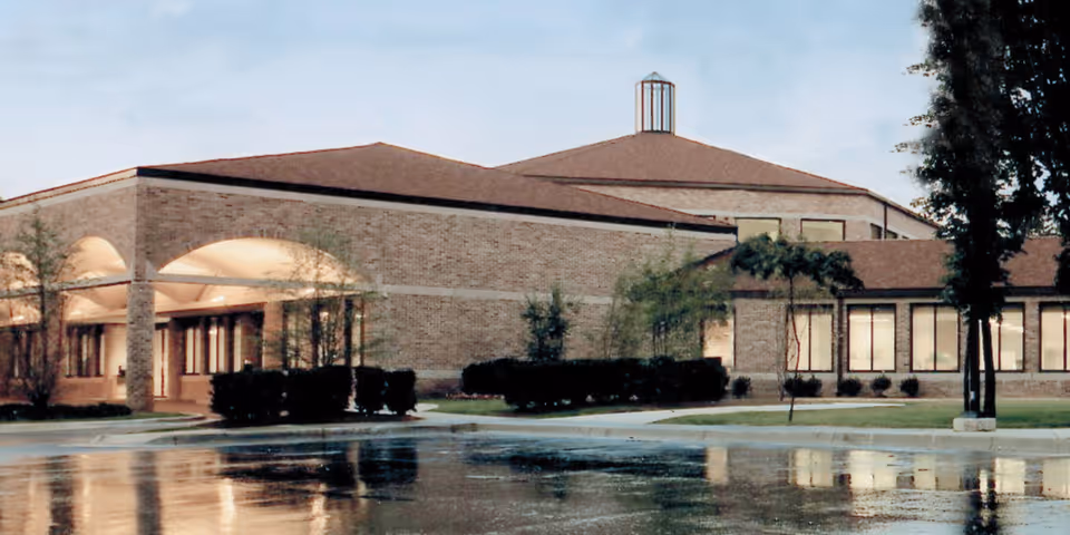 Exterior view of Woodward Hills Nursing Center with brick facade and entrance arches.