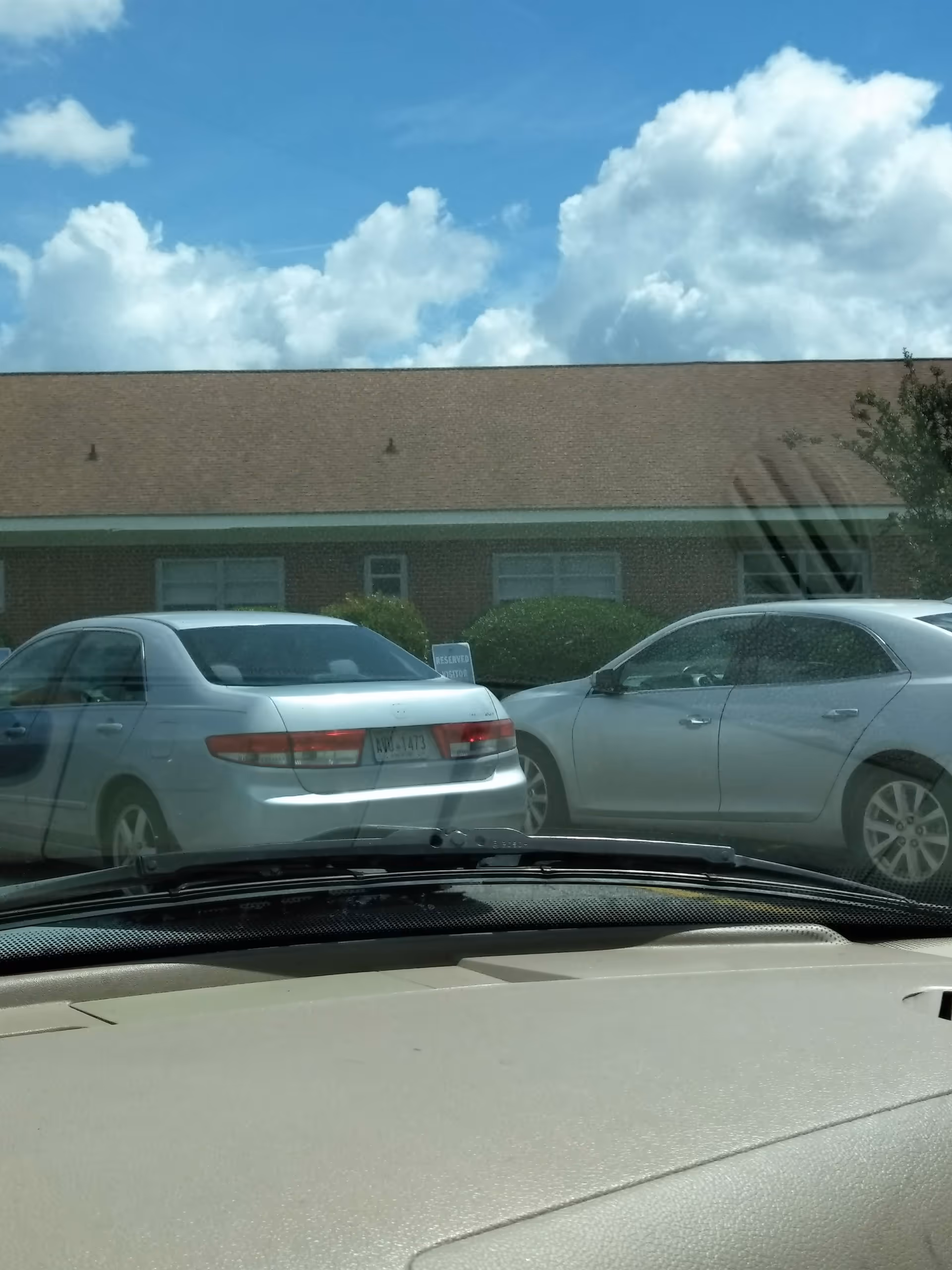 Exterior view of Pruitthealth Palmyra building with parked cars.