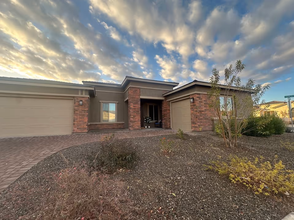 Harvest at Queen Creek Assisted Living exterior with brick facade and desert landscaping.
