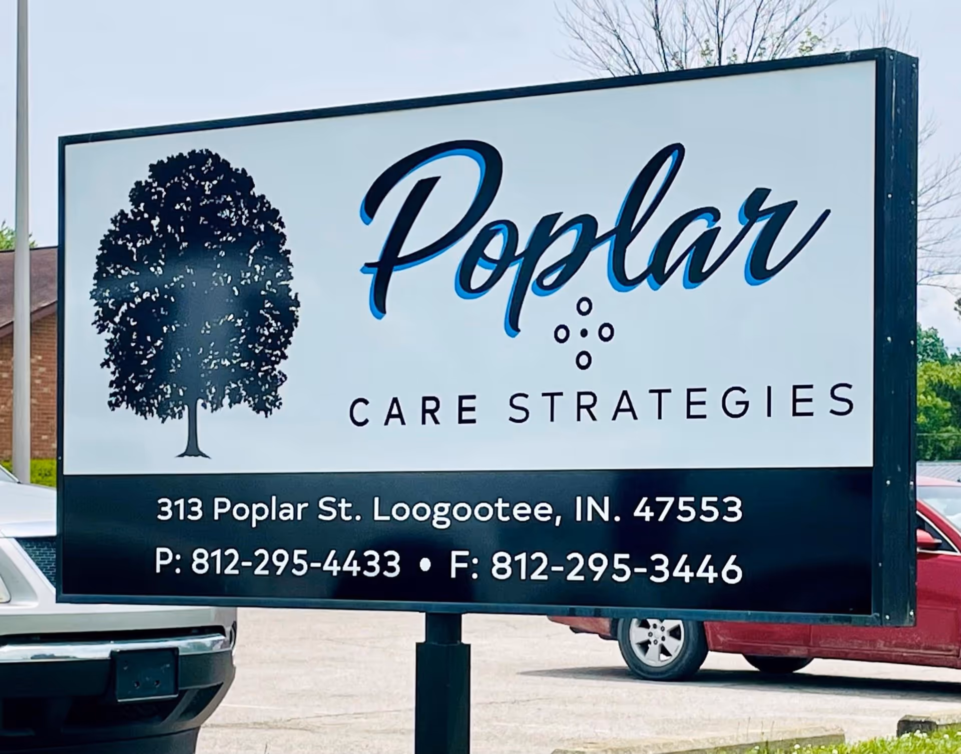 Large exterior sign for Poplar Care Strategies with tree logo and contact details.