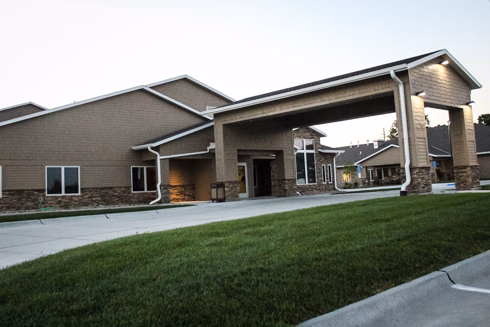 Exterior view of Good Samaritan Society Beatrice with entrance canopy and lawn.