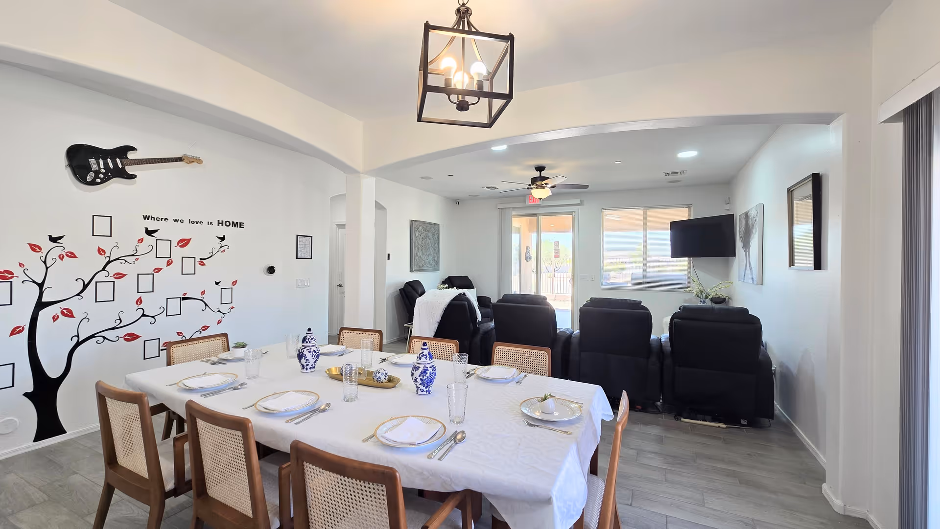 Dining area with a long table set for a meal and lounge seating.