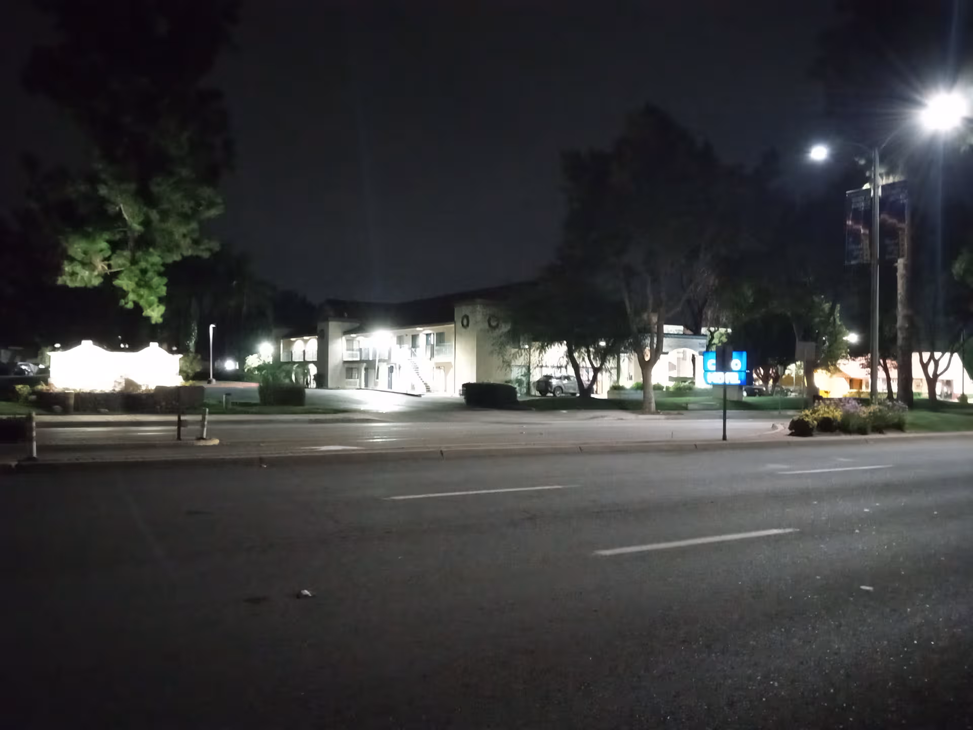 Nighttime exterior view of Meridian at Chino with lit entrance and parking.