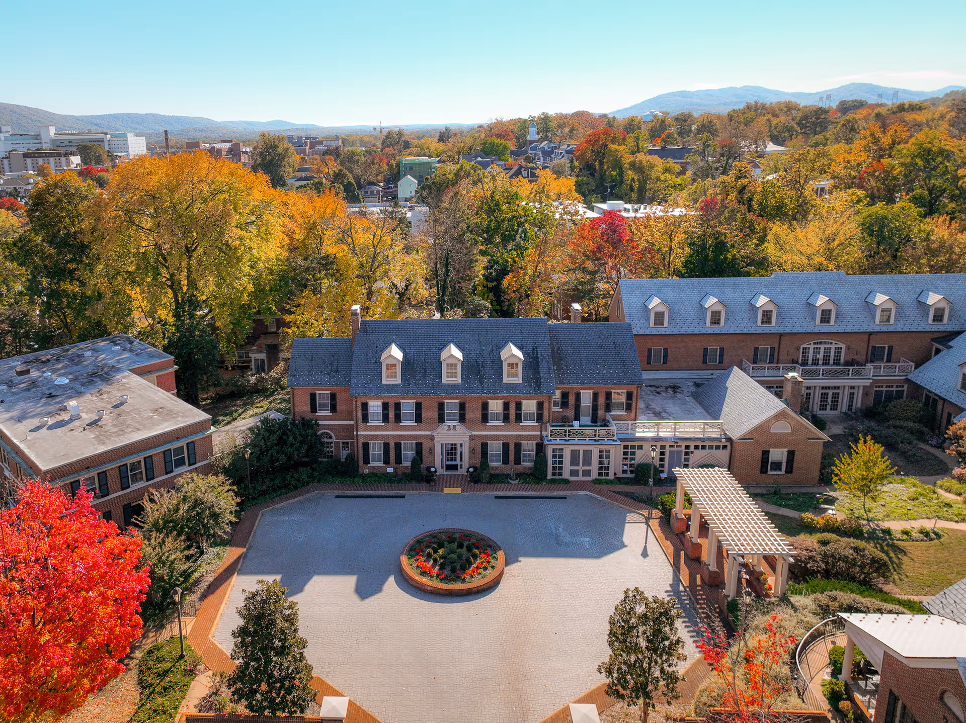 Aerial view of Martha Jefferson House with brick buildings, circular plaza, and autumn trees.