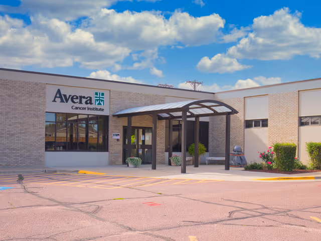 Exterior view of Avera Cancer Institute entrance with a canopy and parking area.