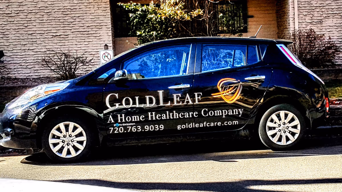 A black GoldLeaf Home Healthcare van with logo parked on a street.