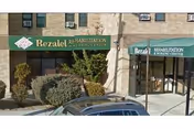 Exterior view of Bezalel Rehabilitation and Nursing Center with green awnings and shrubs