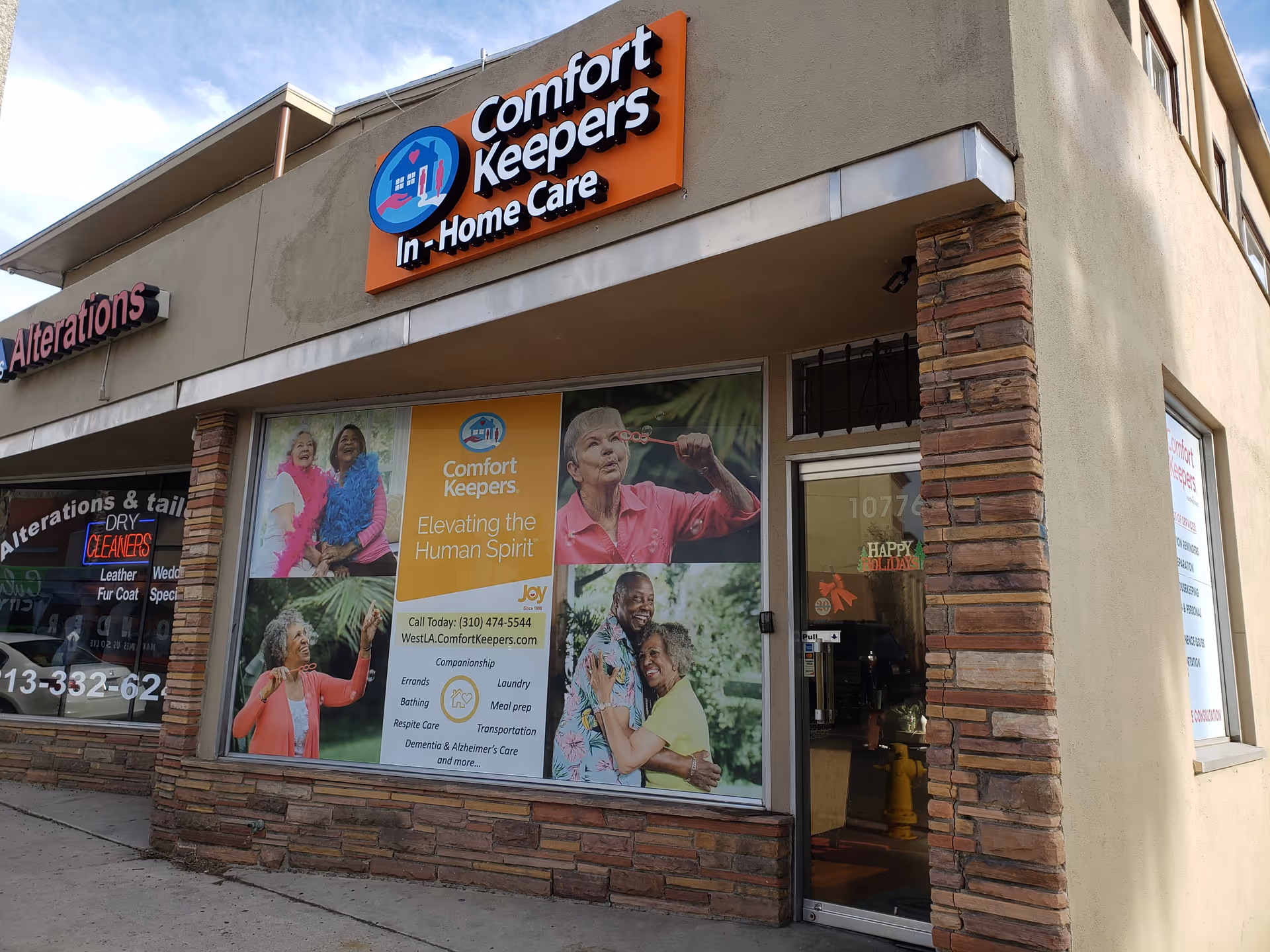 Exterior storefront of Comfort Keepers in Santa Monica with sign and window posters