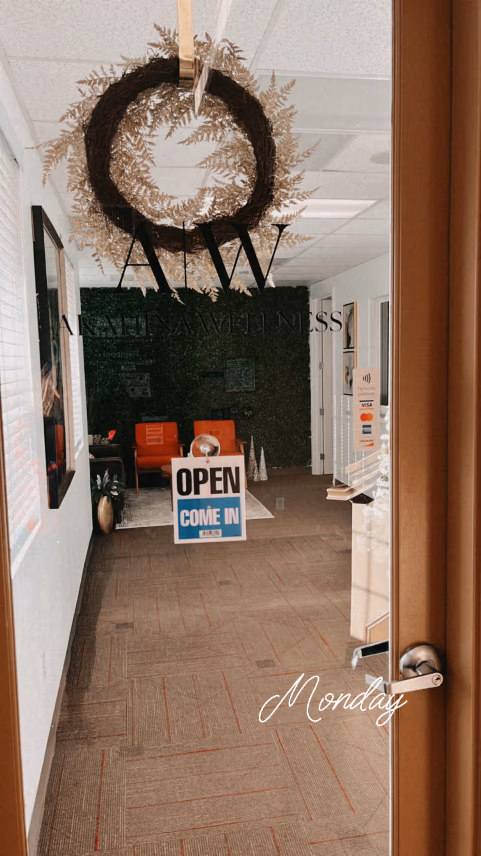 Interior lobby of Akahina Home Care with open sign, wreath, and seating area.